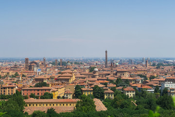 View of the orange medieval skyline of Bologna with brick buildings, seen from the arbours leading to the sanatorium