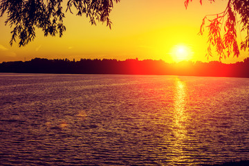 Magical orange sunset over the lake
