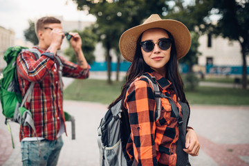 Hikers with backpacks on excursion in tourist town