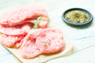 Chop meat-chicken, turkey filen light wooden background.