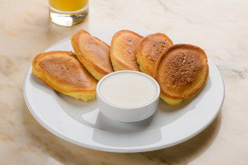 Pancakes served with sour cream