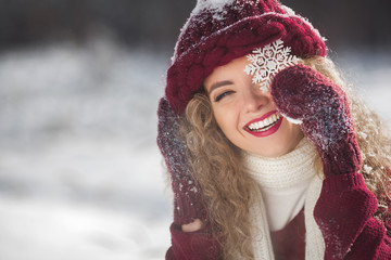 Close up portrait of young beautiful woman on winter background