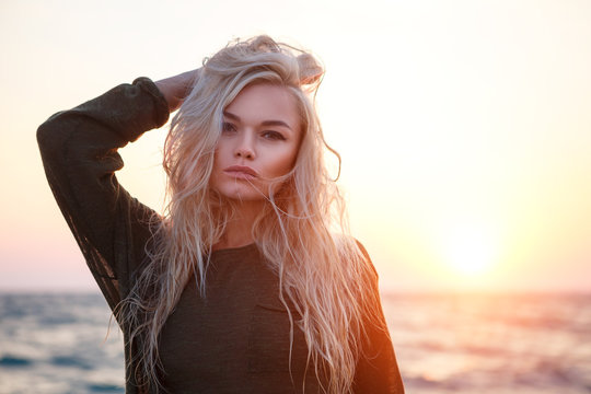 portrait of a beautiful girl on the beach at sunset