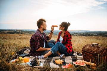 Happy love couple on picnic in summer field