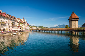 The famous Chapel Bridge (Kapellbrucke) and Water Tower (Wasser Turm) in Lucerne (Luzern), Switzerland. The bridge crosses the river Reuss which debouches into the Lake Lucerne (Vierwaldstattersee). 
