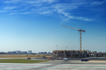 Fototapeta na wymiar Landscape big construction site with large construction crane on blue sky background on summer day.