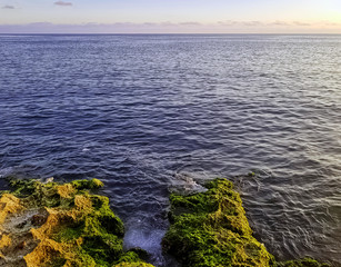 Rocks in front of Malecon and Atlantic Ocean during sunset - Havana, Cuba 