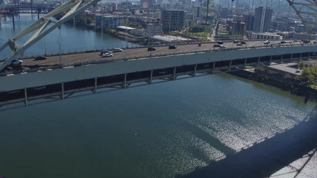 Aerial view tracking shot along side the Fremont Bridge on a sunny day in Portland Oregon