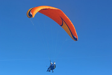 Tandem paraglider flying