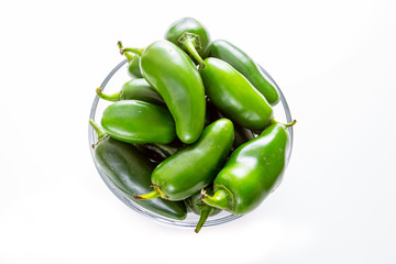 Bowl of Jalapeño peppers in a glass bowl sitting on the kitchen table waiting on the chef to use them