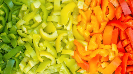 Colorful Bulgarian peppers. Color gradient food background. Close up of green orange red cut pepper. natural healthy food. concept banner of organic shop