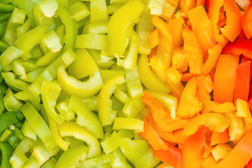 Colorful gradient of Bulgarian peppers. natural healthy food background. Close up of green orange red cut pepper. organic shop