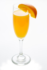 Glass of mimosa cocktail ready to be served for brunch with an orange slice