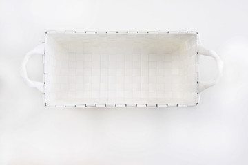 Top view of empty nesting plastic basket on white background, home storage idea