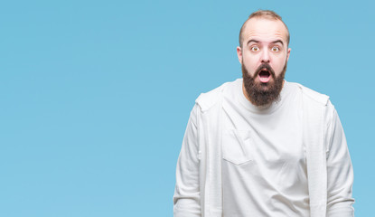Young caucasian hipster man wearing sport clothes over isolated background afraid and shocked with surprise expression, fear and excited face.