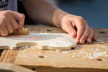 Children learn to make custom violin and other musical instruments in outdoor fablab classes. Joiner's training on makerfaire.