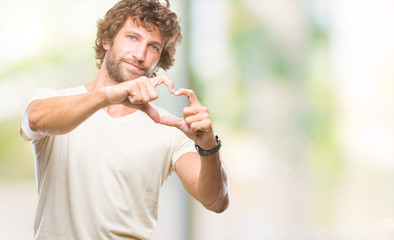 Handsome hispanic model man over isolated background smiling in love showing heart symbol and shape with hands. Romantic concept.