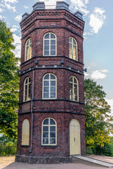 Fototapeta na wymiar An old red bricks tower in a park of Helsinki - 1