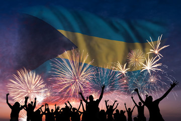 People are looking on fireworks and flag of Bahamas