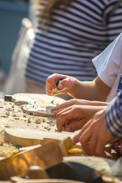 Children learn to make custom violin and other musical instruments in outdoor fablab classes. Joiner's training on makerfaire.