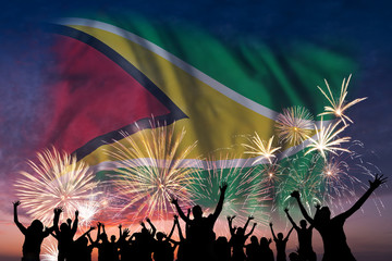 People are looking on fireworks and flag of Guyana
