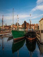 Fototapeta na wymiar Ships on Motlawa river in Gdansk, Poland and oldest medieval port crane 