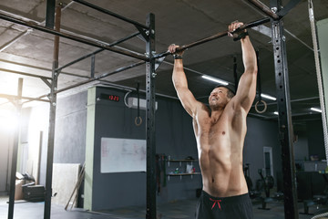 Training. Sports Man Doing Pull Ups Exercise On Sport Rack