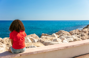 Fototapeta na wymiar Young Woman Girl Teenager Sitting Wall Looking to Sea