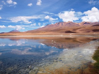 Spectacular view of andean mountains mirrored in the crystal clear water of a toxic lagoon at the landscape of the Altiplano, Bolivia