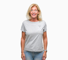 Middle age blonde woman over isolated background afraid and shocked with surprise expression, fear and excited face.