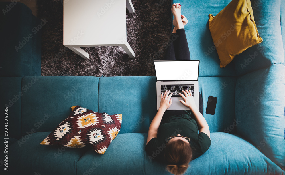 Poster girl using laptop with blank screen top view