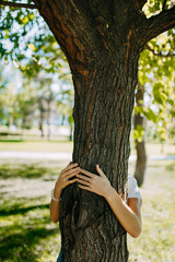 Tree hugging. Close-up of hands hugging tree