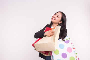 Young asian happy woman with shopping bags on white background with copy space