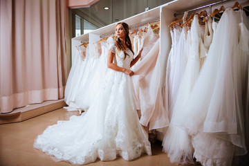 Beautiful bride is trying on an elegant wedding dress