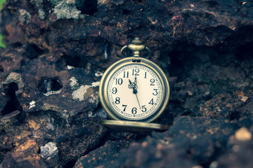 pocket watch on brick with vintage background.