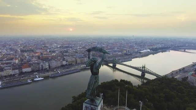 Flying around of Statue of Liberty with the skyline of Budapest at background.