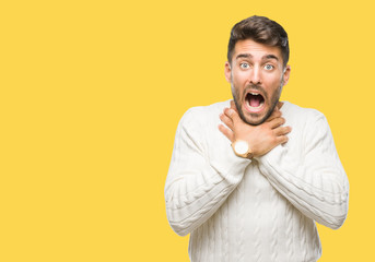 Young handsome man wearing winter sweater over isolated background shouting and suffocate because painful strangle. Health problem. Asphyxiate and suicide concept.