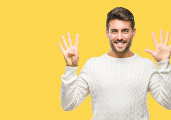 Young handsome man wearing winter sweater over isolated background showing and pointing up with fingers number nine while smiling confident and happy.