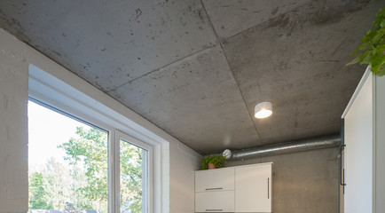 Concrete ceiling and lighting in a modern apartment. Concrete style in the apartment. © Aleks Kend