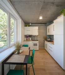 The kitchen and dining room in a modern apartment. Kitchen area in studio apartments. © Aleks Kend