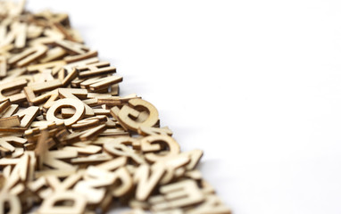 Wooden letters on a pile on left side of a white paper. Copy space.  