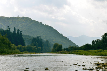 Rocky mountain river on the background of mountains and sky