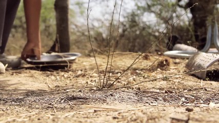 Two Kids Picking Up Trash in the Field.
