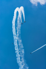 Two Airplanes Drawing a Loop While Two Others are Flying Nearby