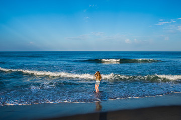A little girl plays in the surf along the oceanfront of the outer banks in North Carolina