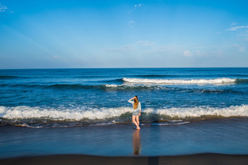 A little girl plays in the surf along the oceanfront of the outer banks in North Carolina