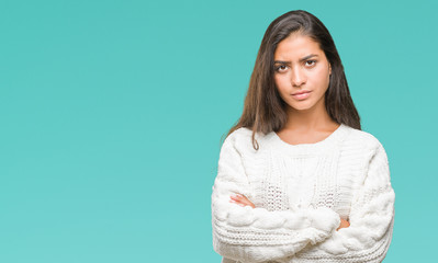 Obraz premium Young beautiful arab woman wearing winter sweater over isolated background skeptic and nervous, disapproving expression on face with crossed arms. Negative person.