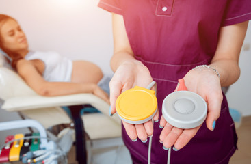 Pregnant woman with electrocardiograph check up for her baby. Fetal heart monitoring