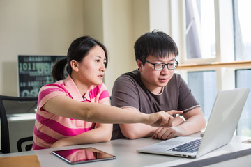 young woman and man working with computer