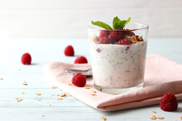 chia pudding with raspberries and granola on a light background. Proper nutrition, super food,...
